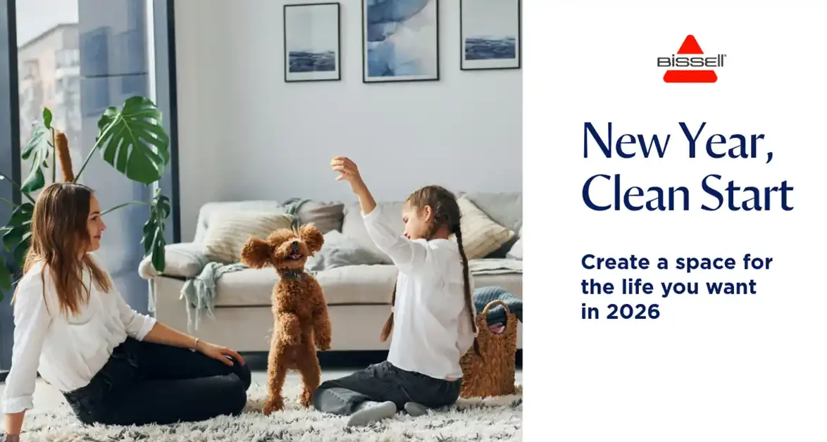 Mother and daughter playing with a small poodle puppy indoors in a modern home, promoting a fresh start for 2026 with BISSELL cleaners.